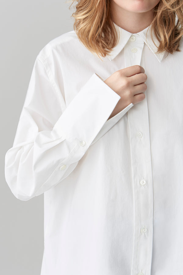 Details of a deep cuff, collar and placket with mother-of-pearl buttons on a crisp cotton poplin shirt.