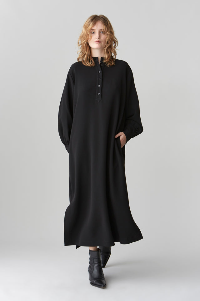 Model wearing JOYCE midi dress with blouson sleeves, featuring a standing collar and button placket, in a relaxed fit.