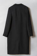 A black, coat with black horn buttoned sleeves and a back vent, showed flat from the back.