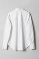 A crisp cotton poplin shirt with high-low curved shirttail hem and deep cuffs showed flat from the back.